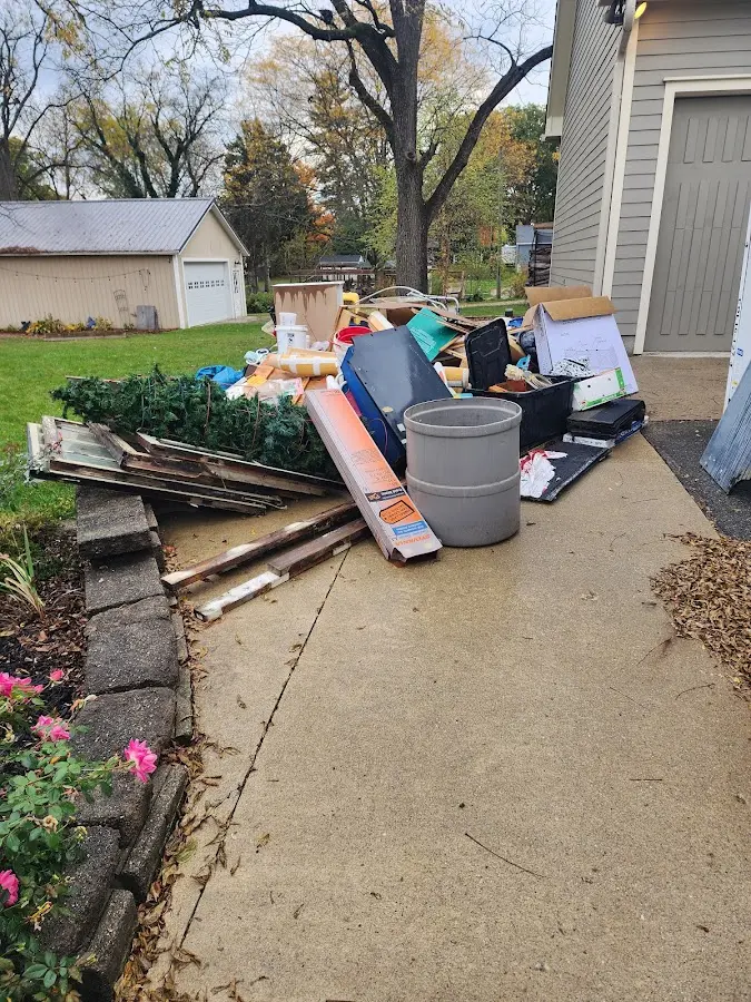 Dumpster being loaded with debris for Demolition Dumpster Rental in Lee